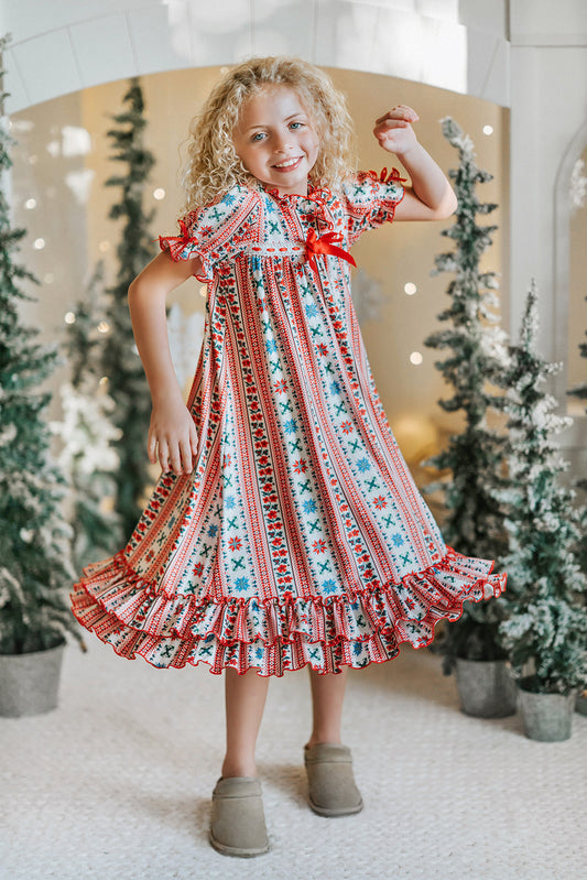 Vinterdal Scandinavian Christmas nightgown for girls with Nordic Fair Isle snowflake print, inspired by Frozen princess Anna and Elsa.
Frozen-inspired girls’ holiday nightgown featuring red and blue Nordic Fair Isle pattern, ruffled hem, and festive Christmas details.
Scandinavian princess nightgown with Fair Isle snowflake design, perfect Christmas sleepwear for Frozen fans and holiday photos.
