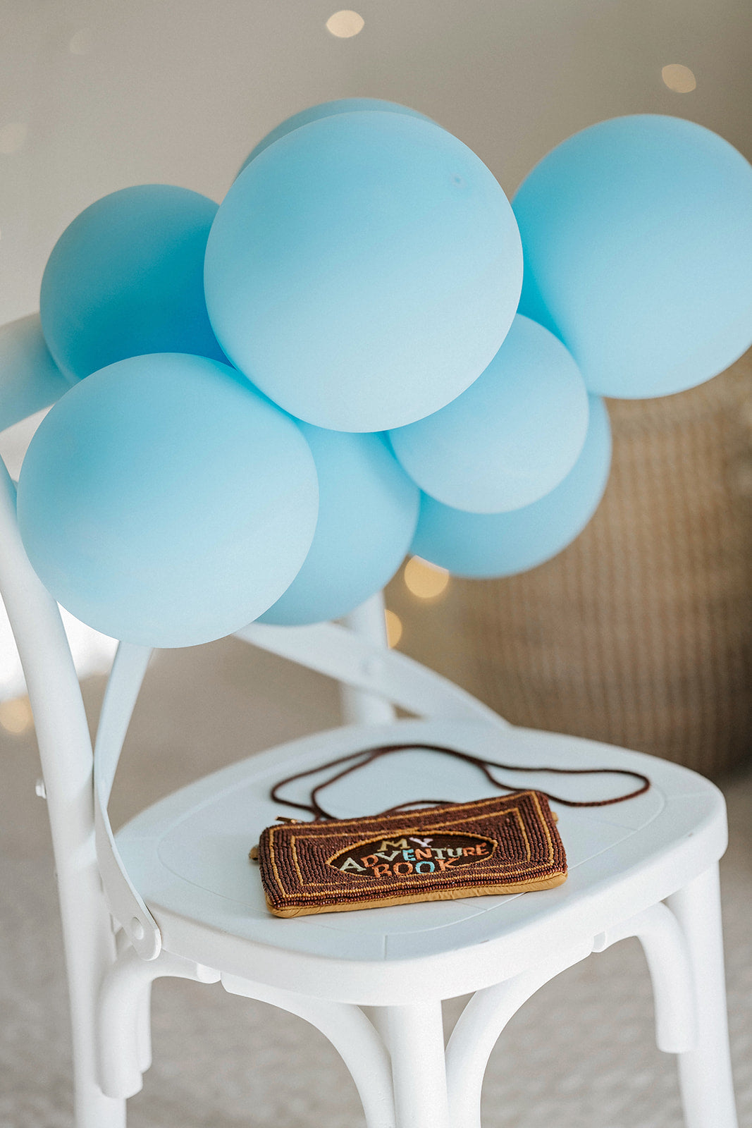 Brown beaded clutch purse with My Adventure Book cover design and multicolor lettering, styled with light blue balloons for an Up birthday party or travel-themed photoshoot.
Pixar Up–inspired beaded handbag with whimsical book cover styling, ideal for gifting to Disney lovers or little explorers heading to Disneyland or a balloon-themed party.
Adventurous crossbody bag for girls or women styled like the Up movie scrapbook, featuring intricate seed bead design and rope-style strap, photographed with pastel