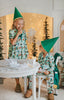 Child dressed in green Christmas pajamas with matching elf cone hat, standing in a winter-themed holiday setup
Boys festive holiday pajamas with playful Christmas print and felt elf hat, styled for family photos and Christmas morning
Toddler in Christmas sleepwear with reindeer and elf hat pattern, wearing slippers in cozy holiday backdrop with twinkle lights