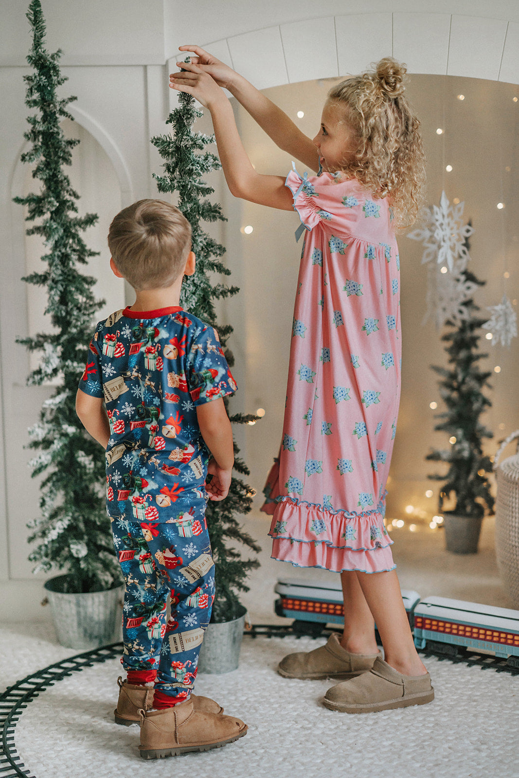 Close-up of child wearing blue striped Polar Express robe with gold bell embroidery on pocket and cozy Christmas pajamas underneath
Kids holiday robe inspired by Polar Express with white piping, gold bell patch, and tie waist, styled for Christmas morning
Blue and white striped Christmas robe with gold bell detail, worn by child with cozy holiday pajamas and slippers
Polar Express-themed unisex robe with gold bell embroidery and piping trim, perfect for kids’ Christmas sleepwear