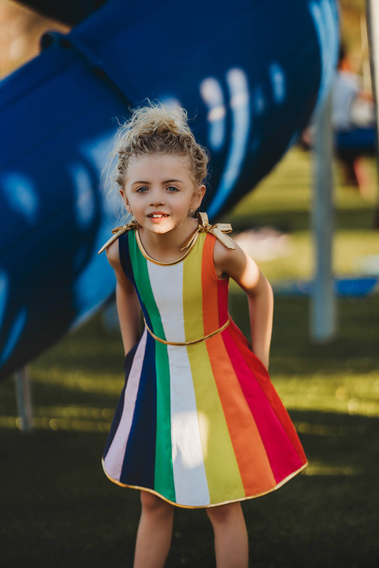Girls rainbow twirl dress with bright stripes and full circle skirt for spinning
Keywords: rainbow twirl dress, pastel dress for girls