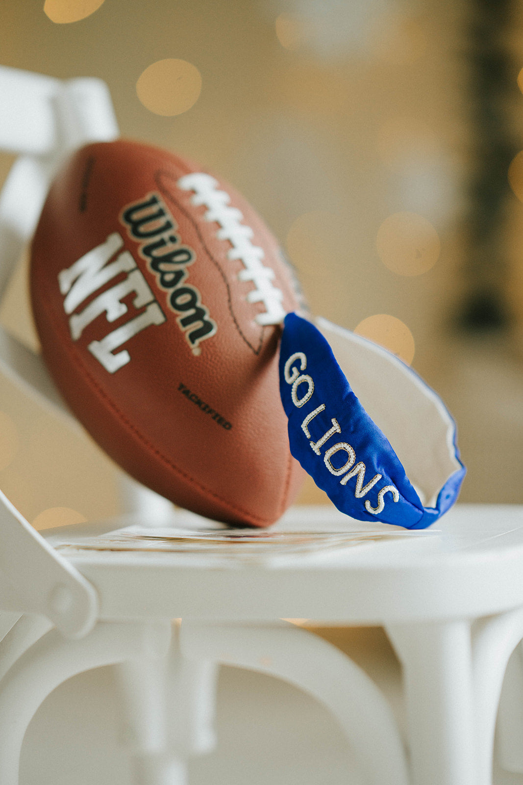 Girl wearing blue “Go Lions” headband holding football on a field at sunset, dressed in white tee and denim shorts
Child wearing sparkly blue team spirit headband that says “Go Lions,” styled with football face sticker and sporty outfit
Little girl showing team pride in “Go Lions” beaded headband while holding football during golden hour on the field
Girls football game day outfit with blue “Go Lions” headband and pigskin, perfect for team spirit wear or cheerleaders