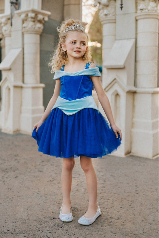 Little girl wearing blue Sleeping Beauty-inspired twirl dress with puff sleeves and satin bodice. Sleeping Beauty blue Disney princess dress. Perfect for a hot park day.
Keywords: Sleeping Beauty dress for girls, blue princess twirl gown