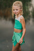 Girl wearing green fairy costume with leaf-style skirt and crop top, styled for dress-up or Tinkerbell-inspired photo shoot
Child in green leaf skirt and matching top posing outdoors, perfect fairy or nature-themed costume for girls
Little girl in Tinkerbell-inspired green outfit with layered leaf skirt and sleeveless top, styled for whimsical dress-up