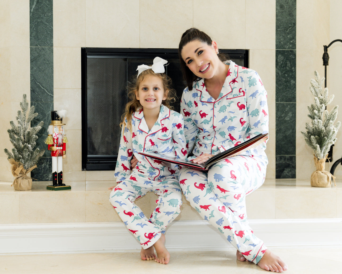 Matching mommy and me dinosaur pajama set with colorful dino print, perfect for bedtime, holidays, or family photos
Mother and child snuggling in coordinating white dinosaur print pajamas with red piping, styled for cozy family moments
Girls and women's matching dino pajamas with fun print, perfect for Christmas, birthdays, or mommy and me photo sessions
Toddler and mom wearing red, green, and blue dinosaur pajamas, hugging and smiling in soft loungewear for holiday or sleepwear gift