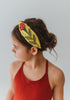 Our Red Rose Princess Headband is comfortable and designed for all day wear. The yellow satin has a red rose embroidered on each side. The rose, stem and leaves have beaded gold details.