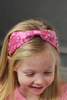 The Iconic Doll Sleeping Beauty Headband is pink satin with crystal rhinestones sewn all over. The headband is comfortable and designed for all day wear. This accessory is perfect for a princess or fashionista.