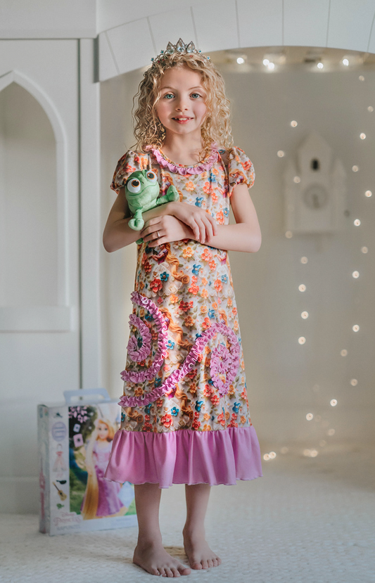 Girls Princess Rapunzel nightgown. Purple ruffles and swirls. Flowers and rapunzel graphics with cap sleeves. Perfect for disney vacation and princess sleepover.