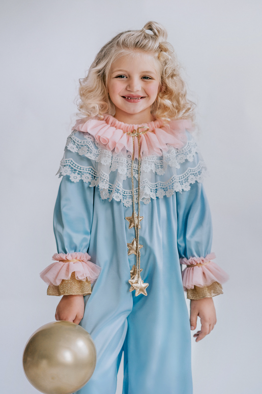 Whimsical toddler clown outfit featuring pastel romper with lace trim and a sparkling gold cape – ideal boutique costume for little girls’ parties and photoshoots.