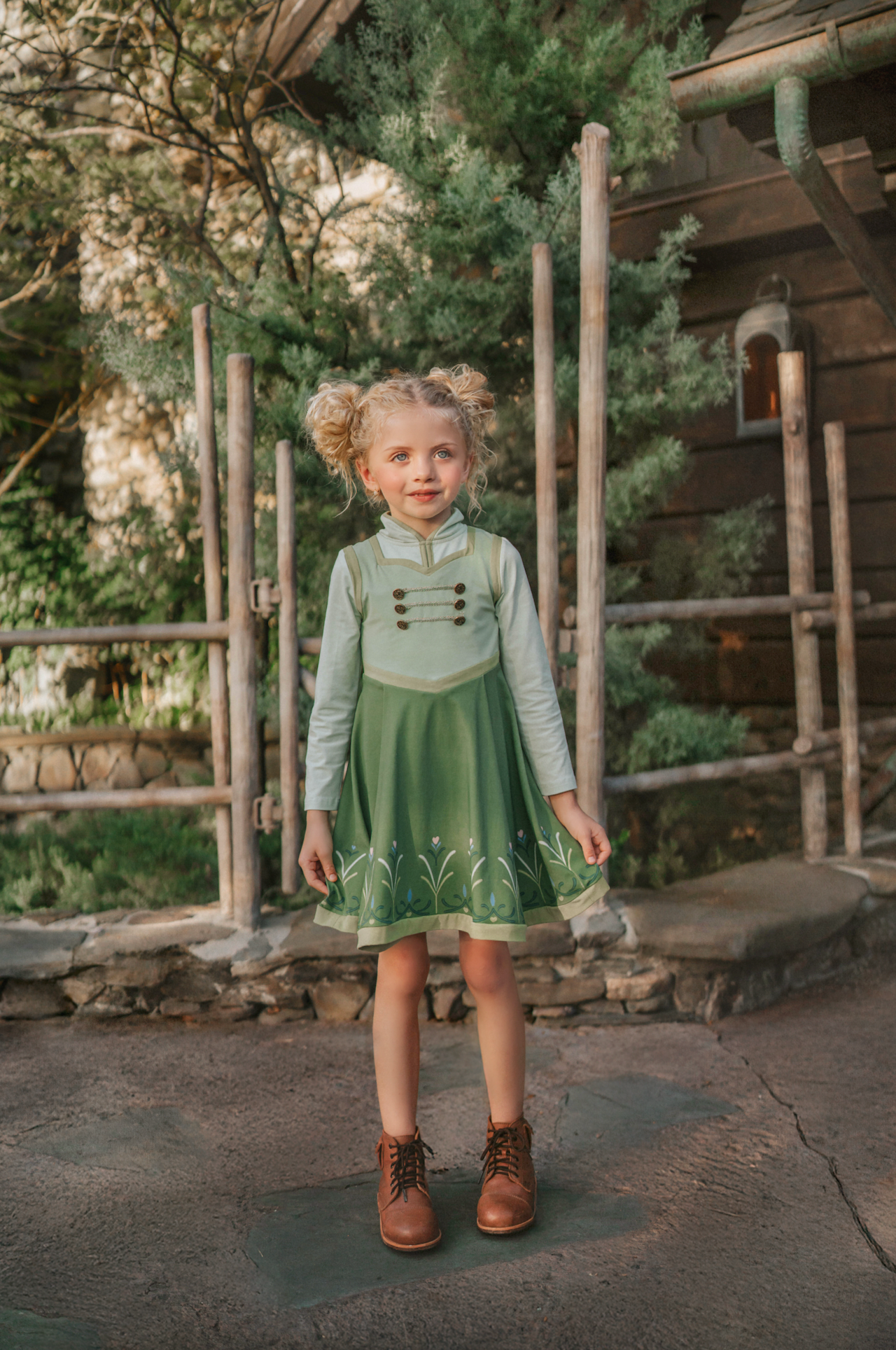 For the first time in forever....a short sleeve cotton twirl dress in spring greens. The bodice is adorned with 6 buttons and iridescent ribbon. There is a faux vest look and the skirt is a bright earthy green with floral pattern on the hem. Perfect for getting out of the castle.