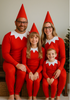 Family in matching red outfits with pointed hats, sitting together.