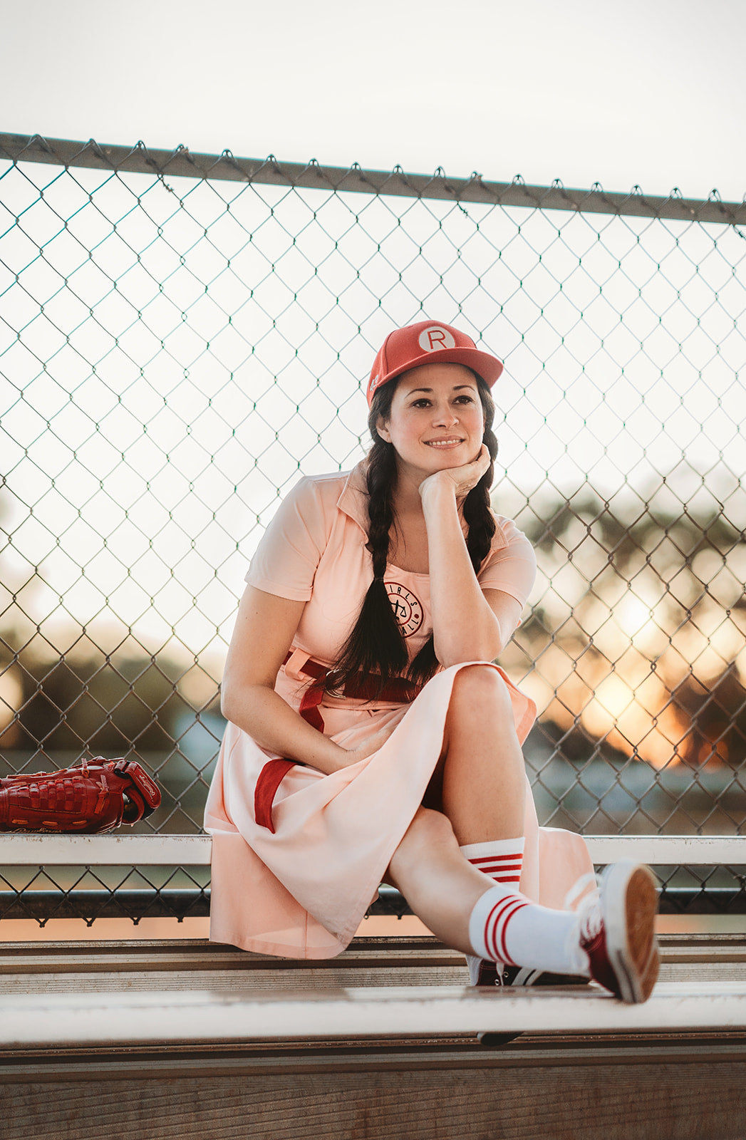 Eden is wearing the Adult Vintage Baseball Dress, styled with a red belt. The outfit is crafted from soft cotton jersey knit fabric and is available in adult sizes.