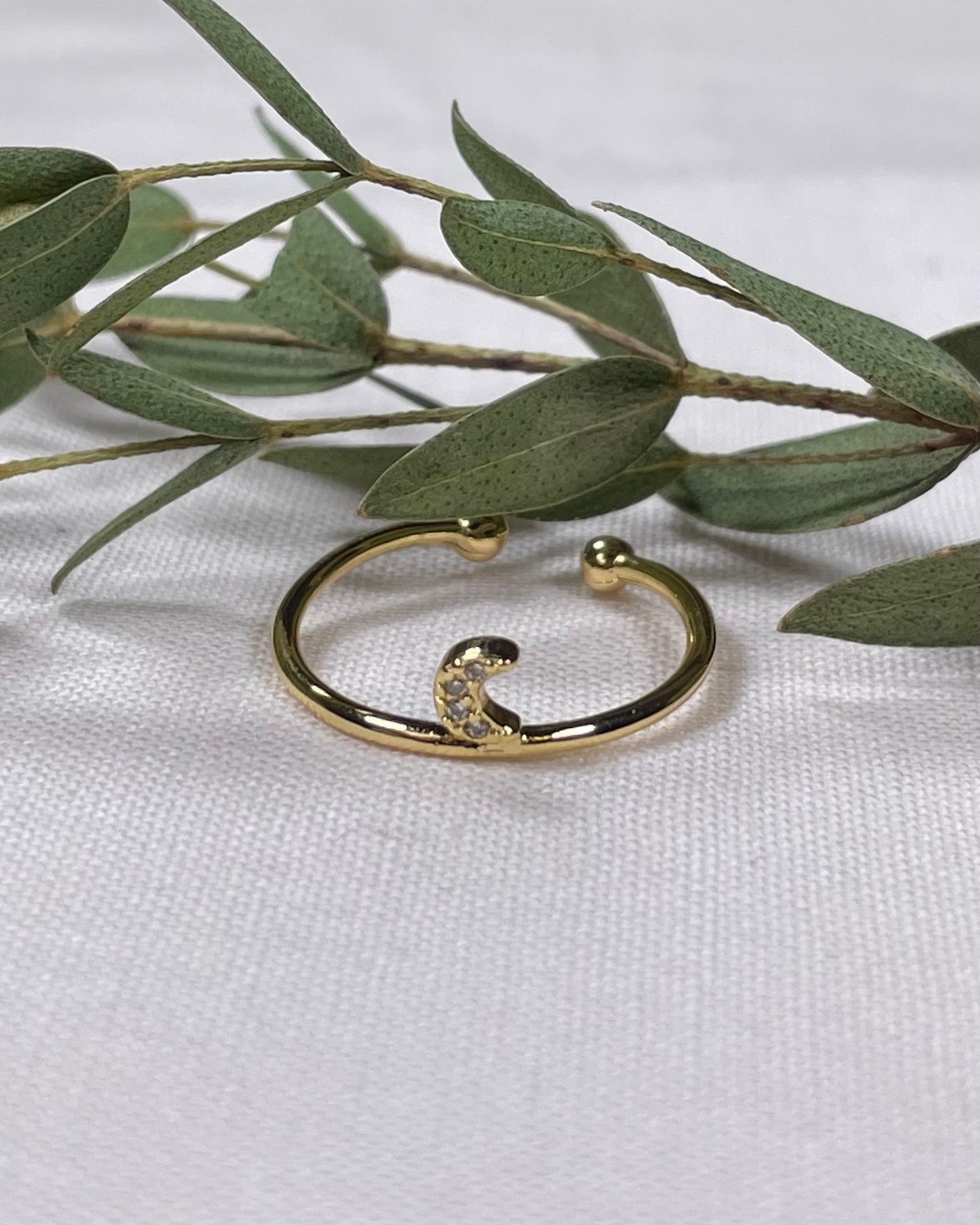 Adjustable golden ring with cresent moon design.