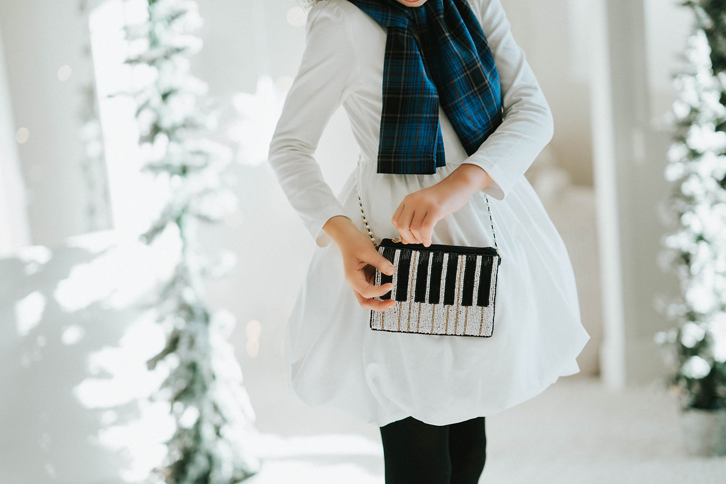 Hand-beaded black and white piano clutch with gold accents and pearl strap, styled on a keyboard for musicians, concert accessories, or music-themed gifts.

Elegant piano key beaded clutch purse with pearl shoulder strap, featuring black and white seed beads and gold shimmer, ideal for recitals or evening events.

Black and white piano beaded purse resting on piano keys, with pearl crossbody strap, styled for music lovers and formal holiday or recital nights.
