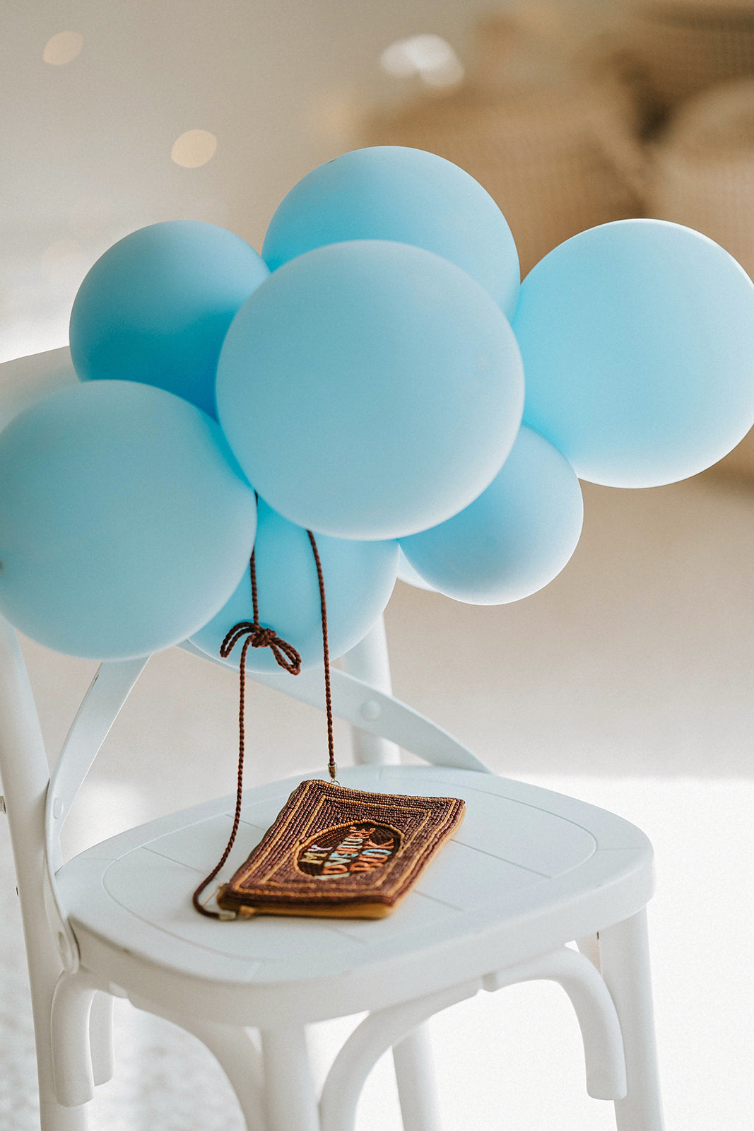 Brown beaded clutch purse with My Adventure Book cover design and multicolor lettering, styled with light blue balloons for an Up birthday party or travel-themed photoshoot.

Pixar Up–inspired beaded handbag with whimsical book cover styling, ideal for gifting to Disney lovers or little explorers heading to Disneyland or a balloon-themed party.

Adventurous crossbody bag for girls or women styled like the Up movie scrapbook, featuring intricate seed bead design and rope-style strap, photographed with pastel