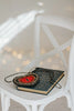 Hand-beaded heart crossbody purse with red center and black trim, styled for gothic princess look with white bubble dress and navy tartan scarf, ideal for Valentine’s Day.

Girls fantasy handbag with keyhole embroidery and red beaded heart design, perfect for magical dress-up, boutique accessories, or romantic themed events.

Unique hand-beaded Valentine’s purse shaped like a heart with black and red seed beads, worn with a winter dress for holiday photo sessions or princess accessories.