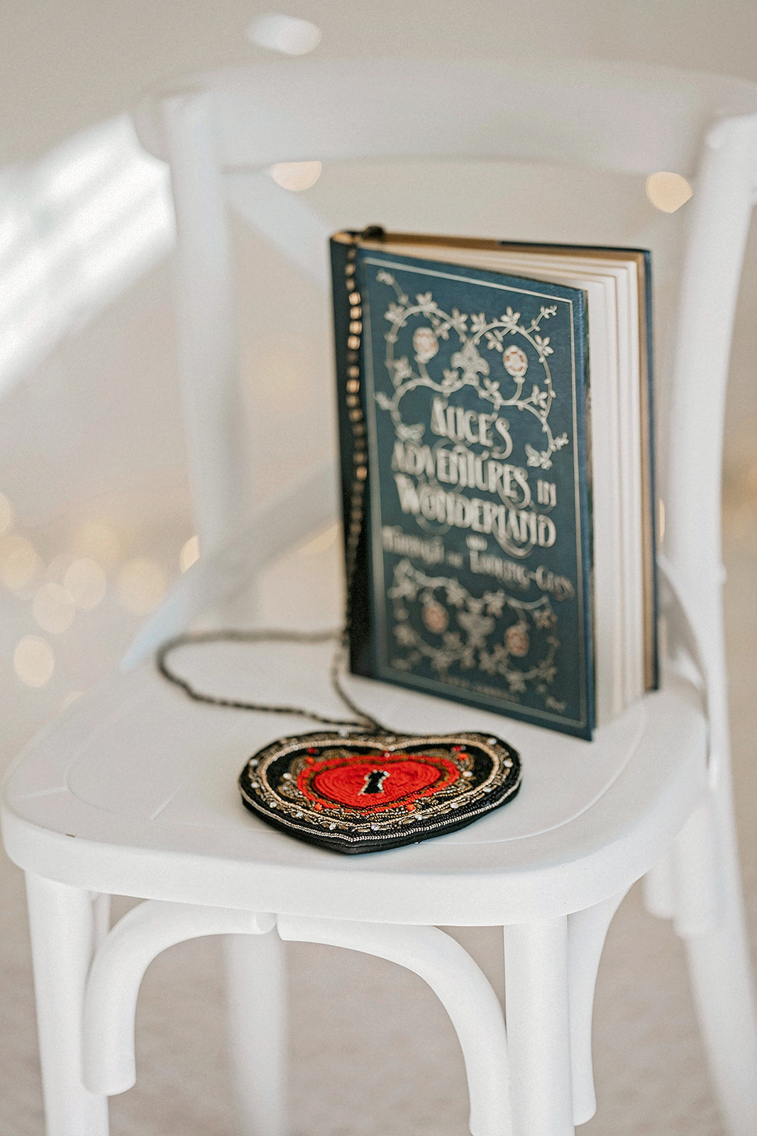 Hand-beaded heart crossbody purse with red center and black trim, styled for gothic princess look with white bubble dress and navy tartan scarf, ideal for Valentine’s Day.

Girls fantasy handbag with keyhole embroidery and red beaded heart design, perfect for magical dress-up, boutique accessories, or romantic themed events.

Unique hand-beaded Valentine’s purse shaped like a heart with black and red seed beads, worn with a winter dress for holiday photo sessions or princess accessories.