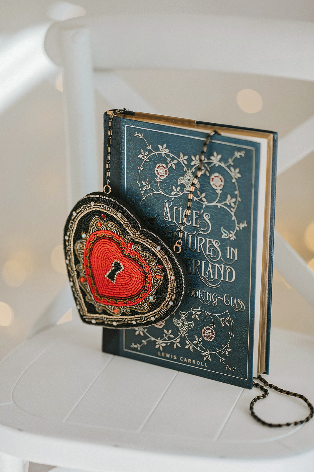 Hand-beaded heart crossbody purse with red center and black trim, styled for gothic princess look with white bubble dress and navy tartan scarf, ideal for Valentine’s Day.

Girls fantasy handbag with keyhole embroidery and red beaded heart design, perfect for magical dress-up, boutique accessories, or romantic themed events.

Unique hand-beaded Valentine’s purse shaped like a heart with black and red seed beads, worn with a winter dress for holiday photo sessions or princess accessories.