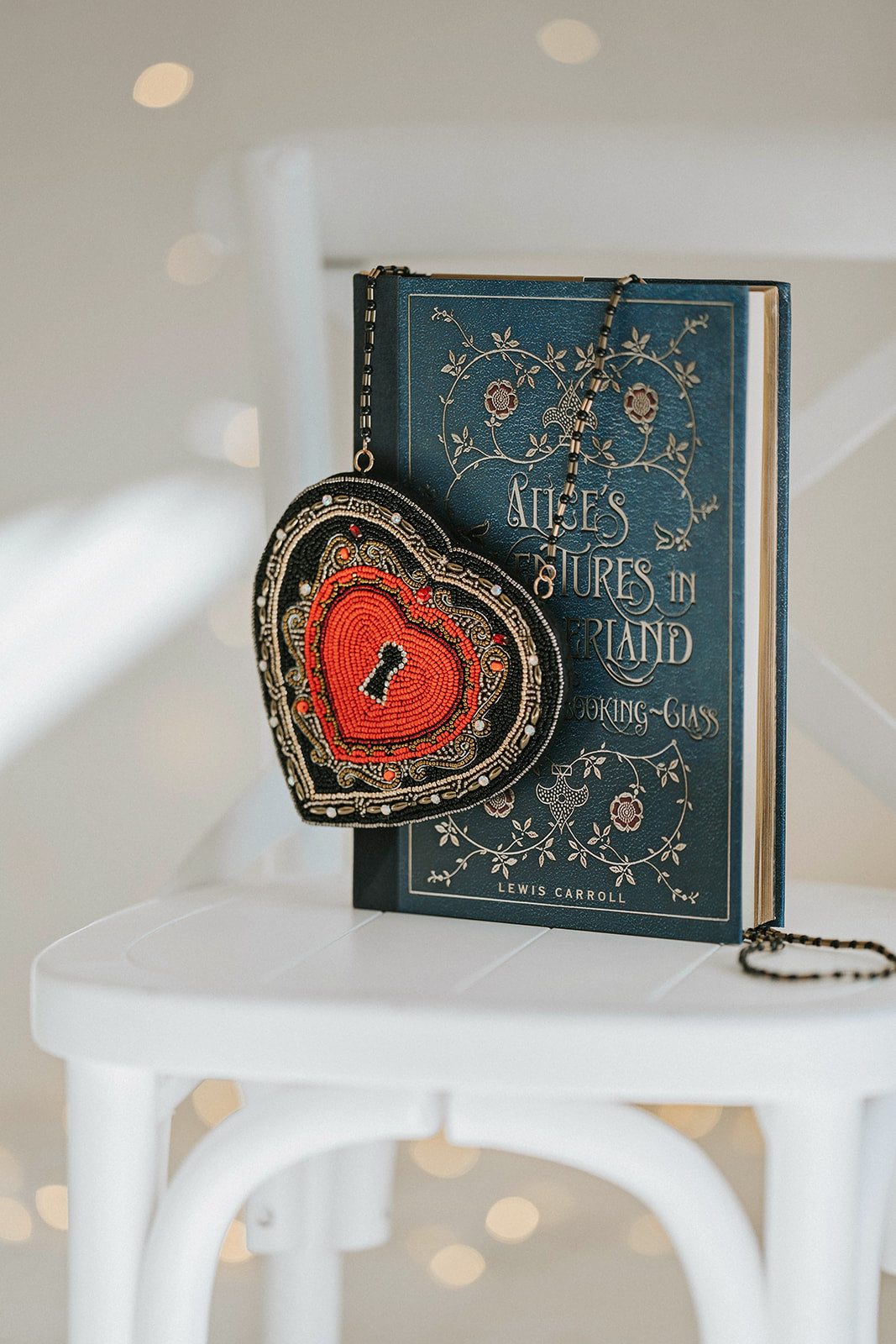 Hand-beaded heart crossbody purse with red center and black trim, styled for gothic princess look with white bubble dress and navy tartan scarf, ideal for Valentine’s Day.

Girls fantasy handbag with keyhole embroidery and red beaded heart design, perfect for magical dress-up, boutique accessories, or romantic themed events.

Unique hand-beaded Valentine’s purse shaped like a heart with black and red seed beads, worn with a winter dress for holiday photo sessions or princess accessories.