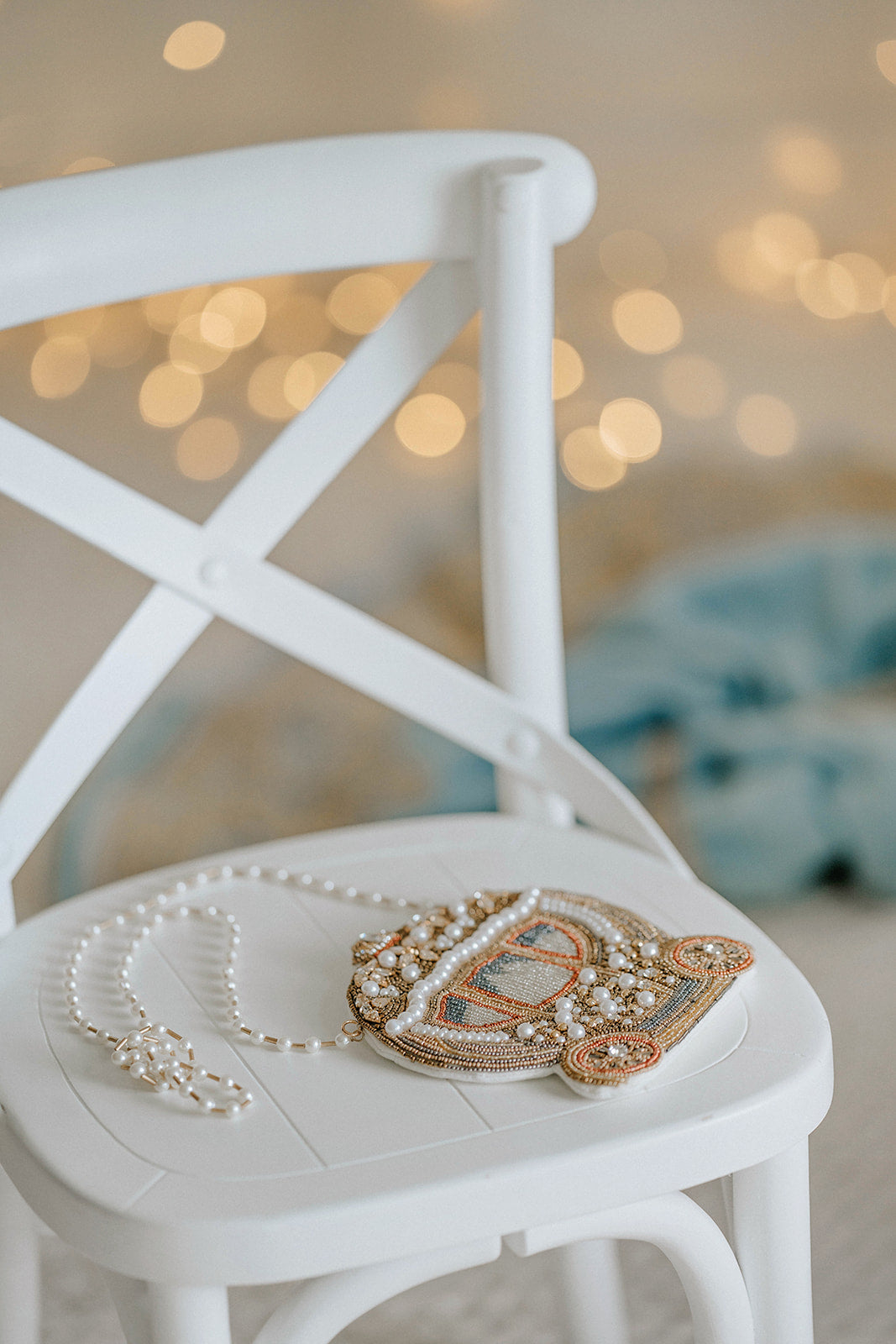 Cinderella-inspired beaded purse shaped like a royal carriage with pearl and gold detailing, styled atop a lace dress for princess birthday, Disney trip, or fairytale wedding.

Close-up of beaded gold carriage bag with pearl accents and vintage design, perfect for Cinderella costume accessory, flower girl outfit, or princess party gift.

Hand-beaded purse shaped like Cinderella’s magical carriage with ivory and gold beads, pearls, and crossbody strap, styled for Disney-loving girls or fairytale weddings.