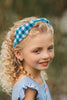 Close-up of child in buffalo check headband and blue outfit, ideal for spring photo shoots or vintage-inspired kids fashion

Blue and white plaid beaded headband on young girl with curly blonde hair, styled outdoors for summer dress-up or gifting

Toddler to tween wearing blue gingham headband, styled with coordinating romper and heart purse for picnic-ready outfit

Hand-beaded gingham headband worn by girl outdoors, featuring classic blue buffalo plaid for timeless cottagecore look