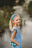 Girl wearing blue gingham beaded headband with ruffled blue romper, perfect for summer, dress-up, or cottagecore style

Close-up of child in buffalo check headband and blue outfit, ideal for spring photo shoots or vintage-inspired kids fashion

Blue and white plaid beaded headband on young girl with curly blonde hair, styled outdoors for summer dress-up or gifting

Toddler to tween wearing blue gingham headband, styled with coordinating romper and heart purse for picnic-ready outfit