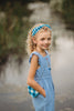 Close-up of child in buffalo check headband and blue outfit, ideal for spring photo shoots or vintage-inspired kids fashion

Blue and white plaid beaded headband on young girl with curly blonde hair, styled outdoors for summer dress-up or gifting

Toddler to tween wearing blue gingham headband, styled with coordinating romper and heart purse for picnic-ready outfit

Hand-beaded gingham headband worn by girl outdoors, featuring classic blue buffalo plaid for timeless cottagecore look