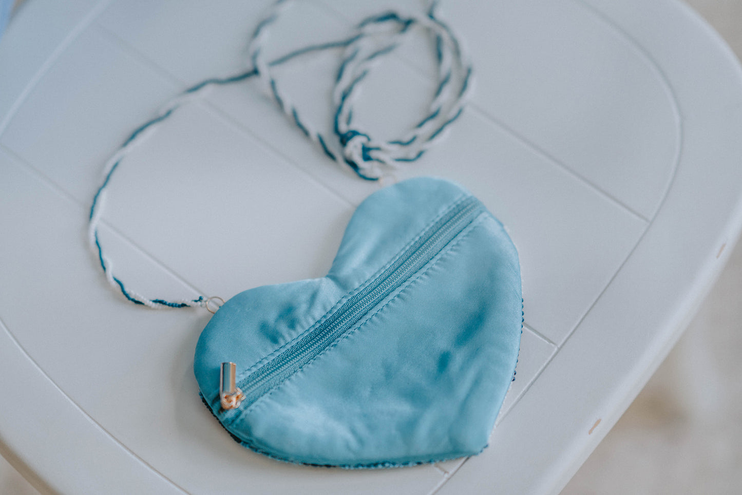 Blue and white gingham heart-shaped beaded purse with braided strap resting on white chair, perfect for girls and toddlers

Close-up of heart-shaped beaded crossbody bag in blue buffalo plaid, styled for spring, Valentine’s Day, or dress-up

Blue gingham heart purse made with delicate beads and braided strap, ideal for toddler gift or cottagecore accessory
