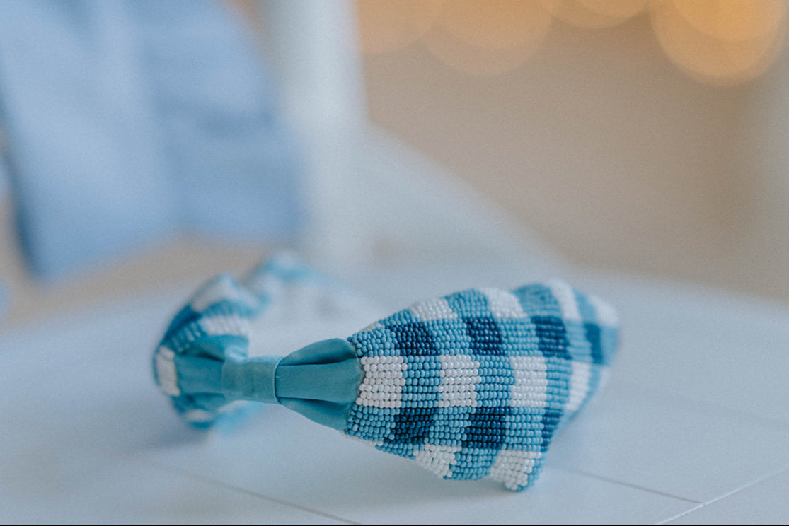Close-up of child in buffalo check headband and blue outfit, ideal for spring photo shoots or vintage-inspired kids fashion

Blue and white plaid beaded headband on young girl with curly blonde hair, styled outdoors for summer dress-up or gifting

Toddler to tween wearing blue gingham headband, styled with coordinating romper and heart purse for picnic-ready outfit

Hand-beaded gingham headband worn by girl outdoors, featuring classic blue buffalo plaid for timeless cottagecore look