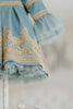 Elegant heirloom girls dress in dusty blue with gold lace trim and tulle layers, hanging on ornate vintage-style mirror

Long sleeve blue and gold embroidered holiday dress for girls, featuring pearl buttons and layered tulle hem

Girls vintage-style formal gown in soft blue with gold lace and flounce sleeves, ideal for portraits or weddings

Classic blue heirloom dress for toddlers and girls with ornate embroidery and pearl detailing, styled for a timeless photo shoot