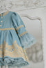 Elegant heirloom girls dress in dusty blue with gold lace trim and tulle layers, hanging on ornate vintage-style mirror

Long sleeve blue and gold embroidered holiday dress for girls, featuring pearl buttons and layered tulle hem

Girls vintage-style formal gown in soft blue with gold lace and flounce sleeves, ideal for portraits or weddings

Classic blue heirloom dress for toddlers and girls with ornate embroidery and pearl detailing, styled for a timeless photo shoot