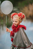 Dancing clown costume for girls in shiny silver and red with dramatic pom-poms and a layered ruffle neckline, perfect for dress-up

Young girl in vintage circus-inspired clown dress holding a balloon, wearing metallic cape with red trim and curly hair buns

Theatrical clown costume for kids with metallic silver fabric and bold red accents, ideal for Halloween or costume party photos