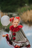 Dancing clown costume for girls in shiny silver and red with dramatic pom-poms and a layered ruffle neckline, perfect for dress-up

Young girl in vintage circus-inspired clown dress holding a balloon, wearing metallic cape with red trim and curly hair buns

Theatrical clown costume for kids with metallic silver fabric and bold red accents, ideal for Halloween or costume party photos