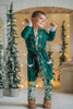 Child dressed in green Christmas pajamas with matching elf cone hat, standing in a winter-themed holiday setup

Boys festive holiday pajamas with playful Christmas print and felt elf hat, styled for family photos and Christmas morning

Toddler in Christmas sleepwear with reindeer and elf hat pattern, wearing slippers in cozy holiday backdrop with twinkle lights