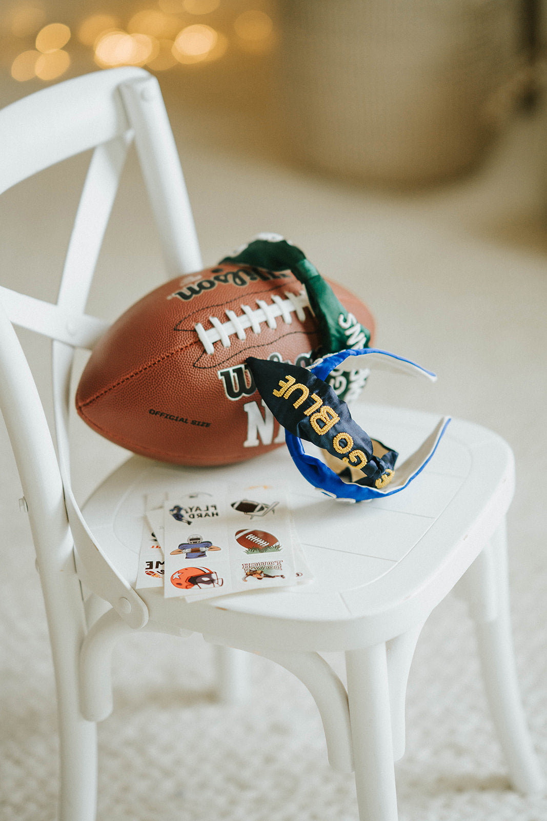 Girl wearing black “Go Blue” headband holding football on grassy field, dressed in white tee and denim shorts for game day

Child showing school spirit in sparkly “Go Blue” headband and football face sticker, styled for sports team support

Little girl wearing team pride headband that says “Go Blue” while smiling and holding a Wilson football outdoors

Blonde girl in football fan outfit with “Go Blue” headband and face paint, standing on a green field during sunset