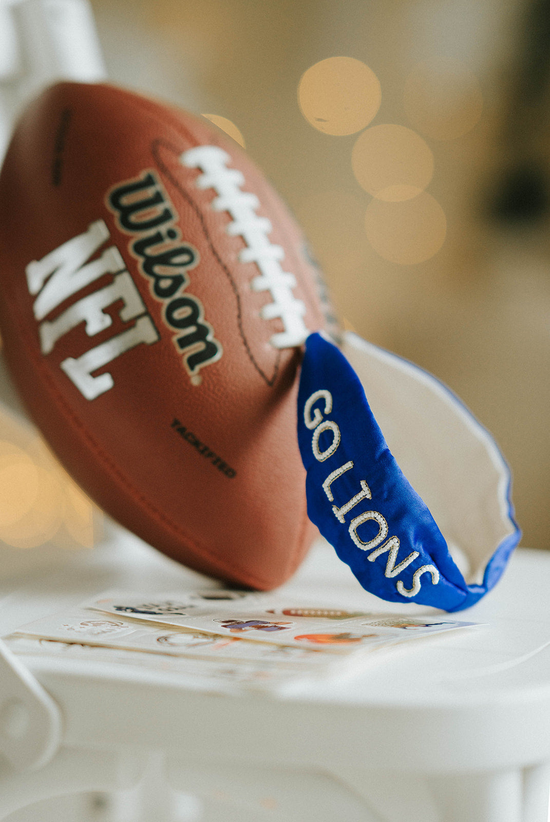 Girl wearing blue “Go Lions” headband holding football on a field at sunset, dressed in white tee and denim shorts

Child wearing sparkly blue team spirit headband that says “Go Lions,” styled with football face sticker and sporty outfit

Little girl showing team pride in “Go Lions” beaded headband while holding football during golden hour on the field

Girls football game day outfit with blue “Go Lions” headband and pigskin, perfect for team spirit wear or cheerleaders