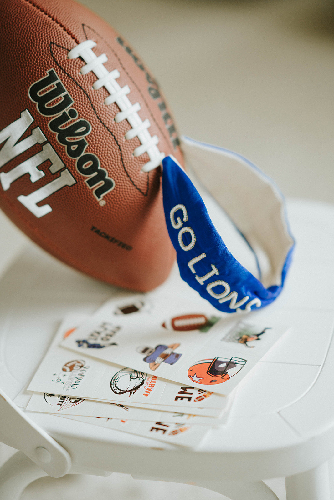 Girl wearing blue “Go Lions” headband holding football on a field at sunset, dressed in white tee and denim shorts

Child wearing sparkly blue team spirit headband that says “Go Lions,” styled with football face sticker and sporty outfit

Little girl showing team pride in “Go Lions” beaded headband while holding football during golden hour on the field

Girls football game day outfit with blue “Go Lions” headband and pigskin, perfect for team spirit wear or cheerleaders