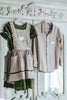 Girls green velvet dress with linen apron featuring embroidered pale blue pumpkin and ruffle trim, perfect for fall photos or Thanksgiving

Heirloom-style green velvet holiday dress with linen pinafore and pumpkin embroidery, styled for autumn or fairytale dress-up

Fall girls outfit with green velvet dress and embroidered pumpkin apron, hanging on vintage white carved mirror

Toddler to tween Thanksgiving dress with velvet base, apron pockets, and embroidered pumpkin design, ideal for family photos