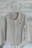Boys beige button-up shirt with embroidered white pumpkin on chest pocket, hanging on vintage carved mirror for fall or Thanksgiving

Neutral boys fall shirt with embroidered pumpkin on pocket, styled for autumn photos, Thanksgiving, or sibling matching sets

Classic boys button-down shirt in light tan with embroidered blue pumpkin, perfect for harvest season or family portraits

Fall button-up shirt for toddlers and boys with embroidered pumpkin pocket detail, styled for Thanksgiving and heirloom outfits

