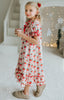 Vintage-style girls Christmas nightgown with red bows, holly print, ruffle trim, and satin bow, hanging on a carved white mirror

Classic holiday pajama dress for girls with red and green holly print, ruffle hem, and red satin bow at the neckline

Girls long sleeve Christmas nightgown with festive red bow and holly pattern, styled for holiday photos or heirloom gifting

Traditional girls holiday nightgown in white with red and green floral print, ruffle accents, and lace trim