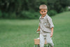 Boys beige button-up shirt with embroidered white pumpkin on chest pocket, hanging on vintage carved mirror for fall or Thanksgiving

Neutral boys fall shirt with embroidered pumpkin on pocket, styled for autumn photos, Thanksgiving, or sibling matching sets

Classic boys button-down shirt in light tan with embroidered blue pumpkin, perfect for harvest season or family portraits

Fall button-up shirt for toddlers and boys with embroidered pumpkin pocket detail, styled for Thanksgiving and heirloom outfits

