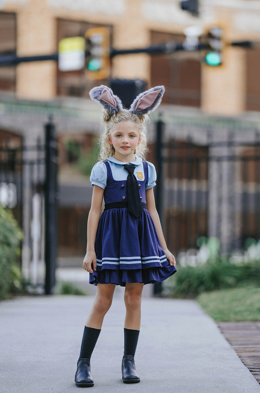 Girls Judy Hopps police costume dress inspired by Zootopia with blue puff sleeves, gold badge patch, and black tie detail

Zootopia-inspired girls dress with Judy Hopps police uniform design, featuring blue tones, tie, and badge for dress-up or Halloween

Toddler to tween Judy Hopps costume dress with pleated navy skirt, striped trim, and puff sleeve top styled like a bunny cop uniform
