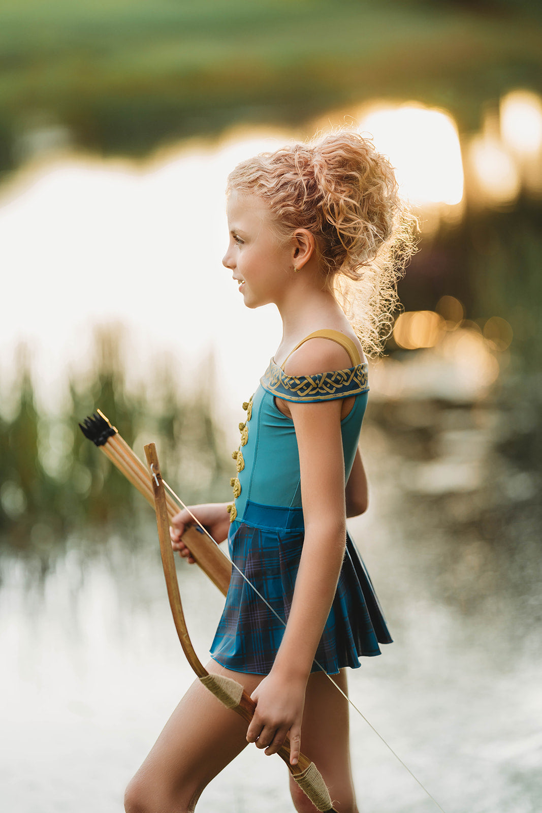 Scottish archer one-piece bathing suit with off-shoulder straps and golden knot trim, styled for adventurous girls

Tartan princess swimsuit with corset-style top and pleated sides, designed for play, pool, and pretend royalty

Celtic warrior girls swimsuit with gold embroidery and blue plaid accents, inspired by fairytales and Highland legends