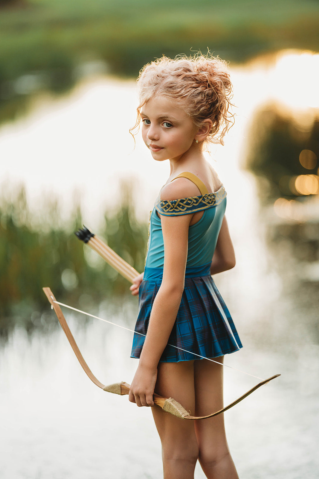 Scottish archer one-piece bathing suit with off-shoulder straps and golden knot trim, styled for adventurous girls

Tartan princess swimsuit with corset-style top and pleated sides, designed for play, pool, and pretend royalty

Celtic warrior girls swimsuit with gold embroidery and blue plaid accents, inspired by fairytales and Highland legends