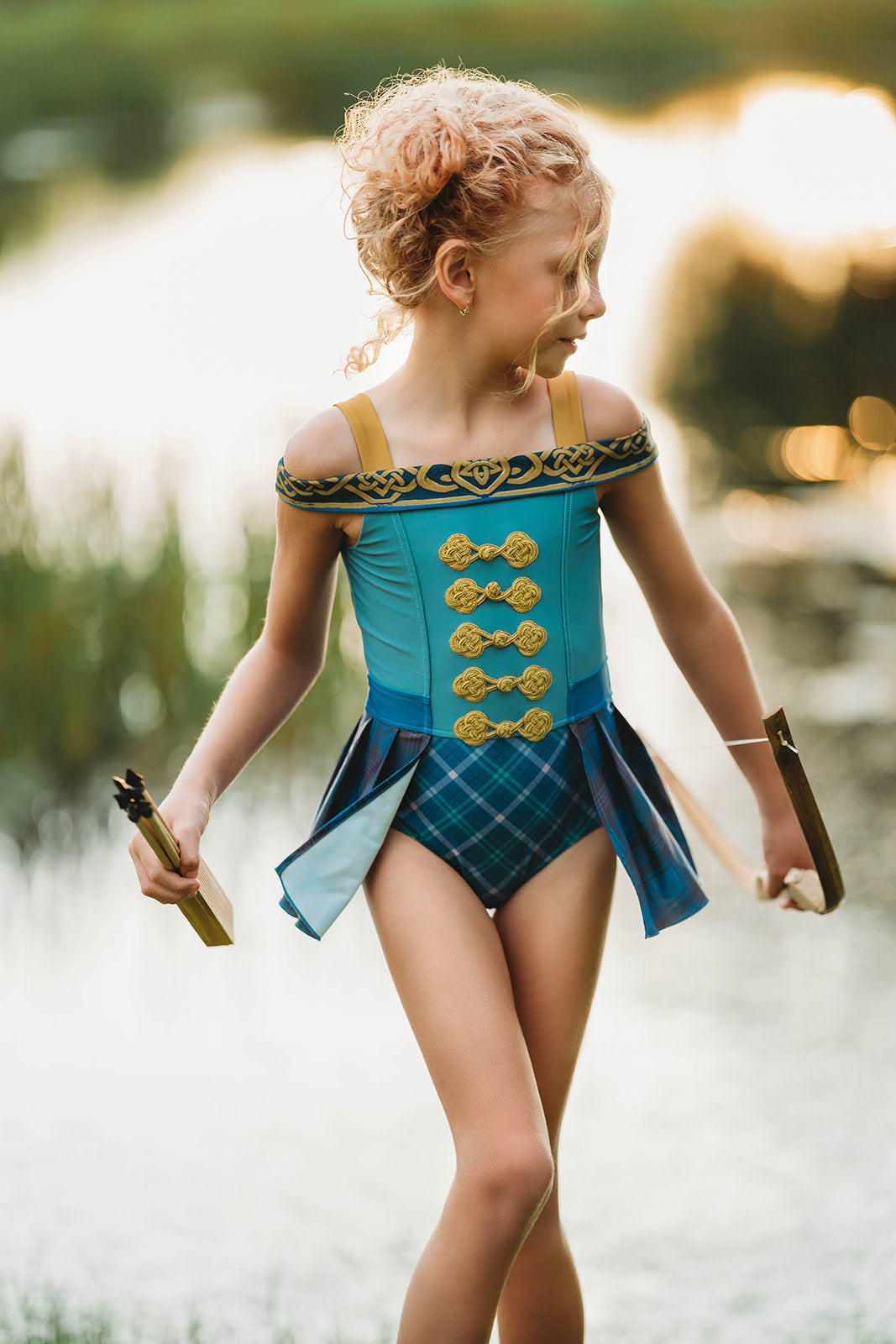Girls Brave-inspired one-piece swimsuit with Celtic details, tartan pleats, and gold embroidery, styled for dress-up at the lake

Fantasy princess swimsuit with warrior-style bodice and plaid skirt panels, perfect for magical swim days or costume play

Scottish archer one-piece bathing suit with off-shoulder straps and golden knot trim, styled for adventurous girls