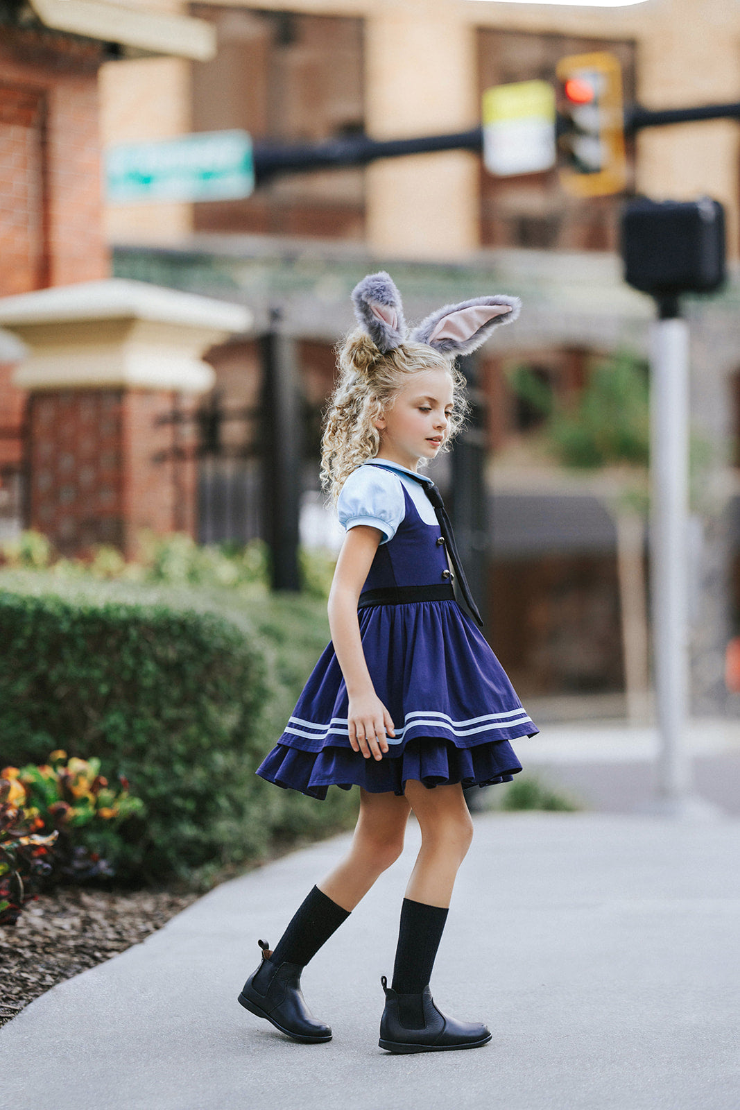 Girls Judy Hopps police costume dress inspired by Zootopia with blue puff sleeves, gold badge patch, and black tie detail

Zootopia-inspired girls dress with Judy Hopps police uniform design, featuring blue tones, tie, and badge for dress-up or Halloween

Toddler to tween Judy Hopps costume dress with pleated navy skirt, striped trim, and puff sleeve top styled like a bunny cop uniform