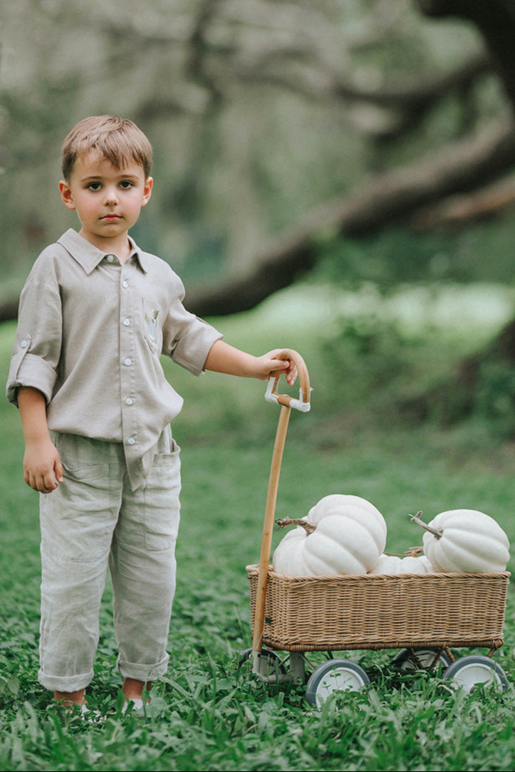 Boys beige button-up shirt with embroidered white pumpkin on chest pocket, hanging on vintage carved mirror for fall or Thanksgiving

Neutral boys fall shirt with embroidered pumpkin on pocket, styled for autumn photos, Thanksgiving, or sibling matching sets

Classic boys button-down shirt in light tan with embroidered blue pumpkin, perfect for harvest season or family portraits

Fall button-up shirt for toddlers and boys with embroidered pumpkin pocket detail, styled for Thanksgiving and heirloom outfits

