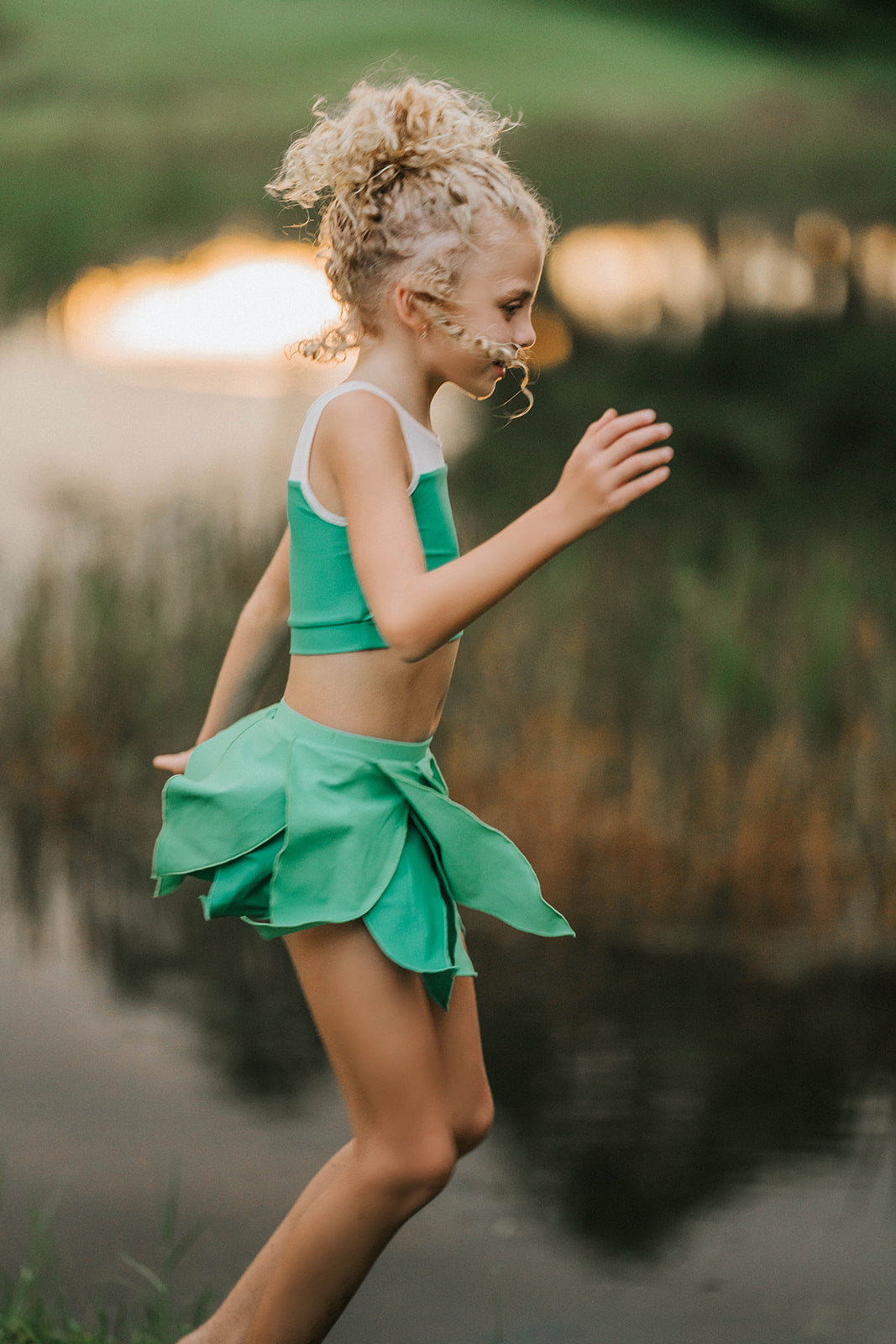 Young girl dressed in green two-piece leaf fairy costume, ideal for Halloween, themed birthdays, or magical dress-up play