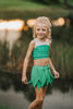 Young girl dressed in green two-piece leaf fairy costume, ideal for Halloween, themed birthdays, or magical dress-up play