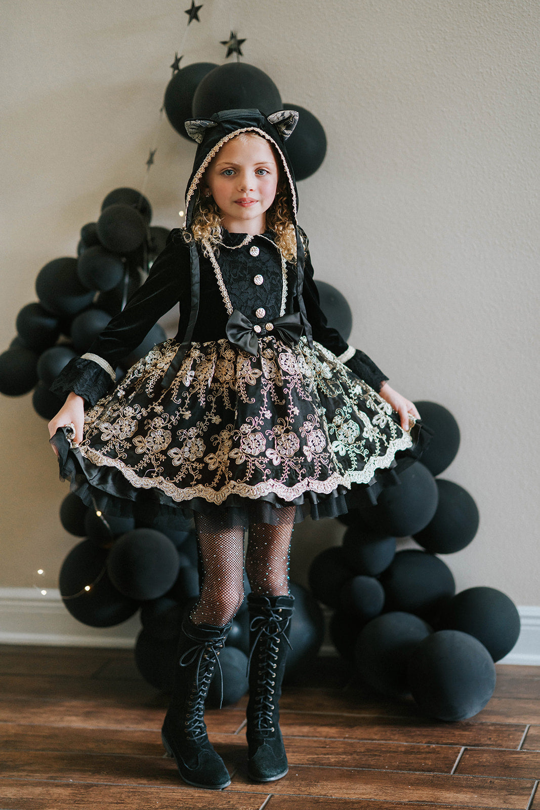 Girl wearing black velvet cat costume dress with gold embroidery, hooded ears, and satin bow, styled for Halloween or dress-up play

Elegant girls Halloween cat dress with hooded velvet top, gold lace trim, and full embroidered skirt, styled for spooky season

Gothic black and gold cat costume for girls with velvet hood, embroidered skirt, and satin bow, perfect for Halloween photoshoots

Child in hooded black cat dress with gold embroidery and velvet bodice, styled for Victorian Halloween or fairytale play